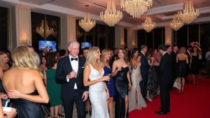 Oameni eleganți la o petrecere sofisticată, modă sezonieră.